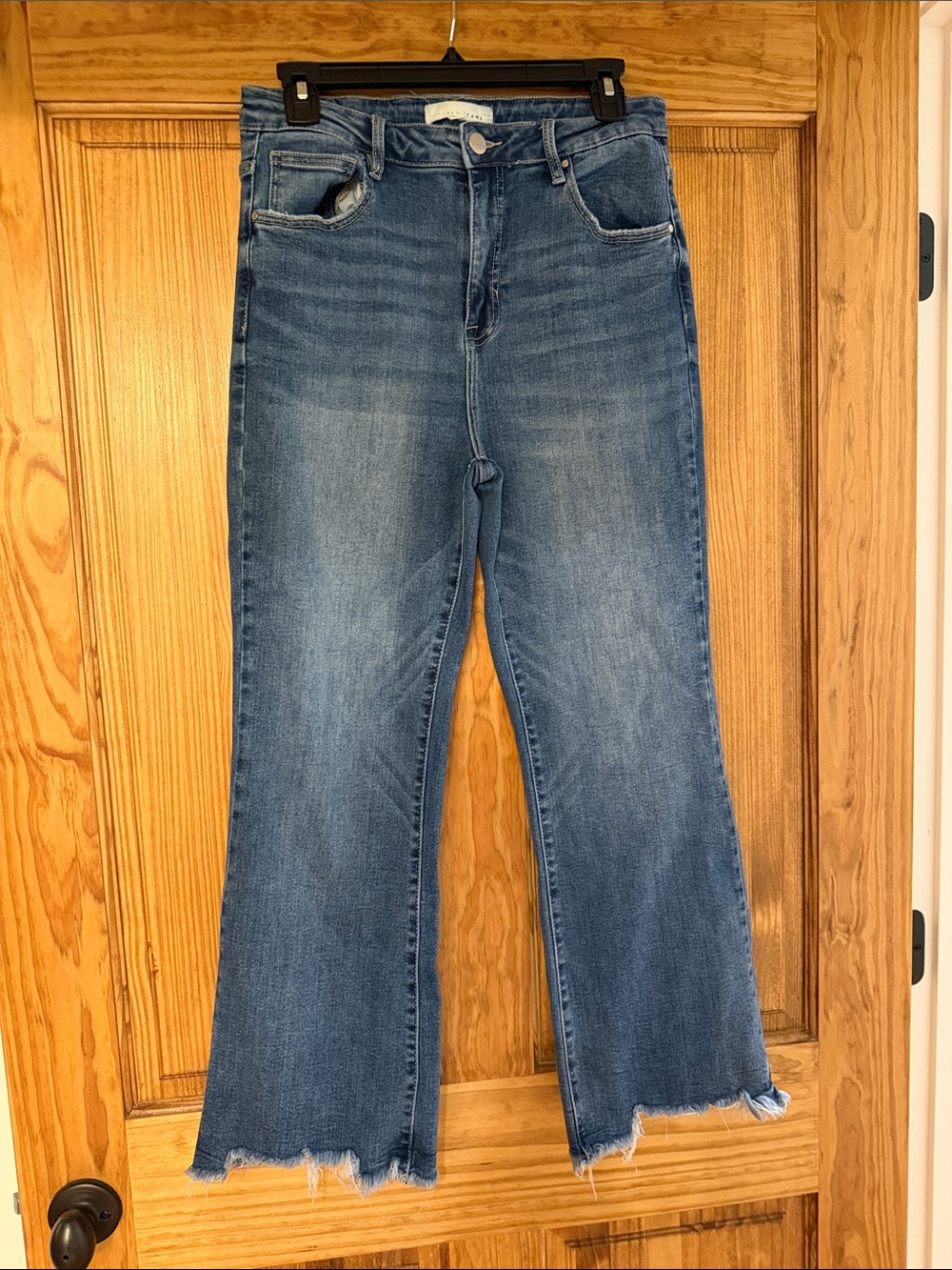 Risen High-Rise Flare Jeans in Medium Blue with Raw Hem